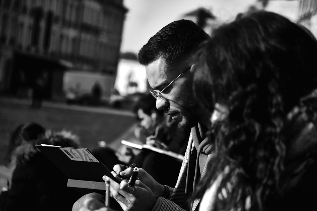 Journalist taking notes during interview outdoors
